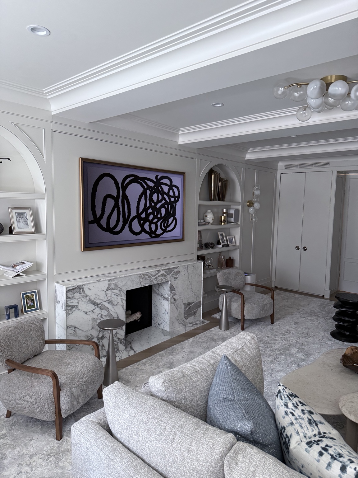 Framed display above a marble fireplace